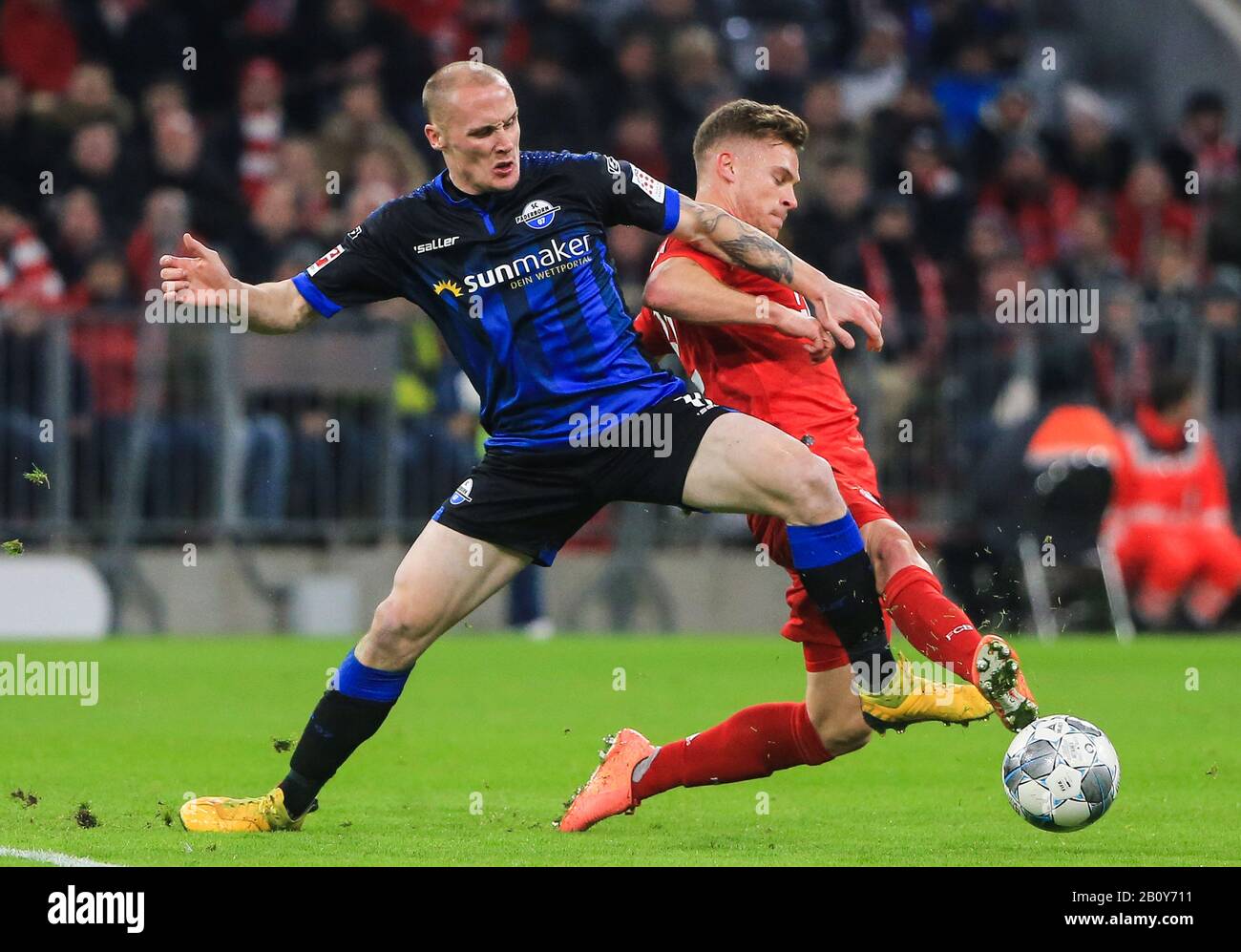 Munich, Germany. 21st Feb, 2020. Joshua Kimmich (R) of Bayern Munich vies  with Sven Michel of Paderborn during a German Bundesliga match between FC Bayern  Munich and SC Paderborn 07 in Munich,