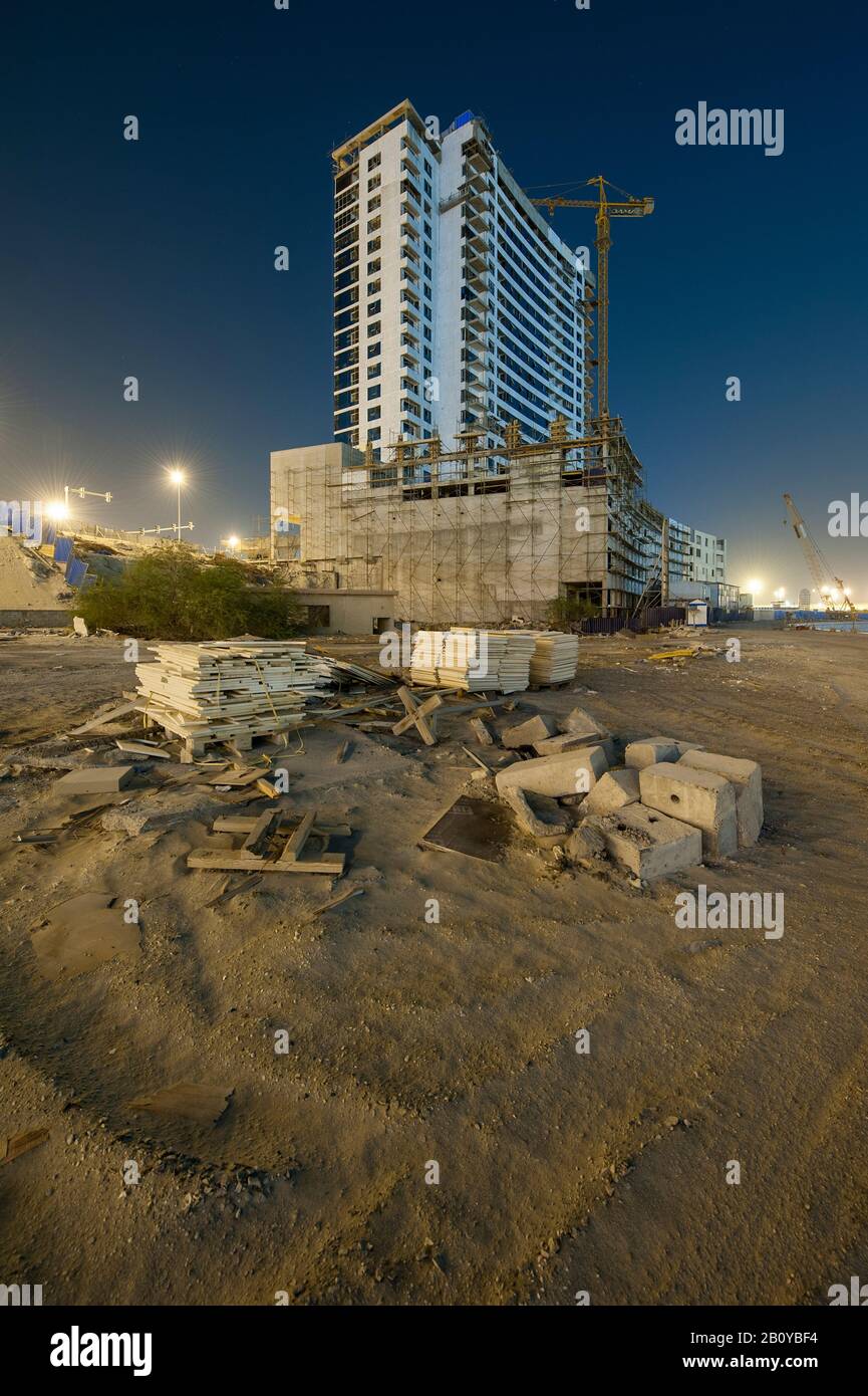 Construction site of a high-rise building in Sports City at night, Dubai, United Arab Emirates, Stock Photo