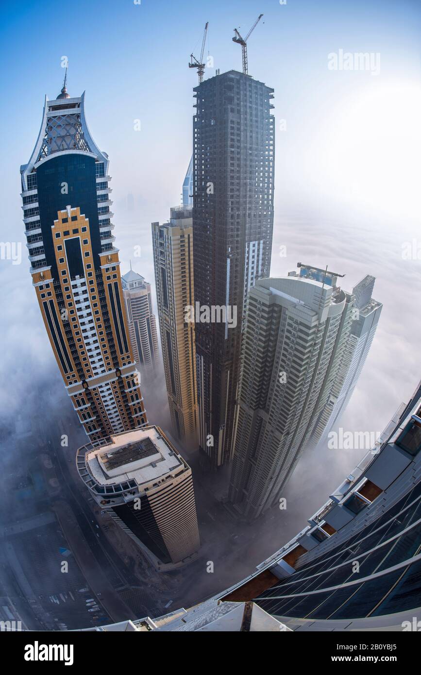 Tallest blocks of the Tallest Block on the Planet in Marina in the morning mist at sunrise, Fisheye, New Dubai, United Arab Emirates, Stock Photo