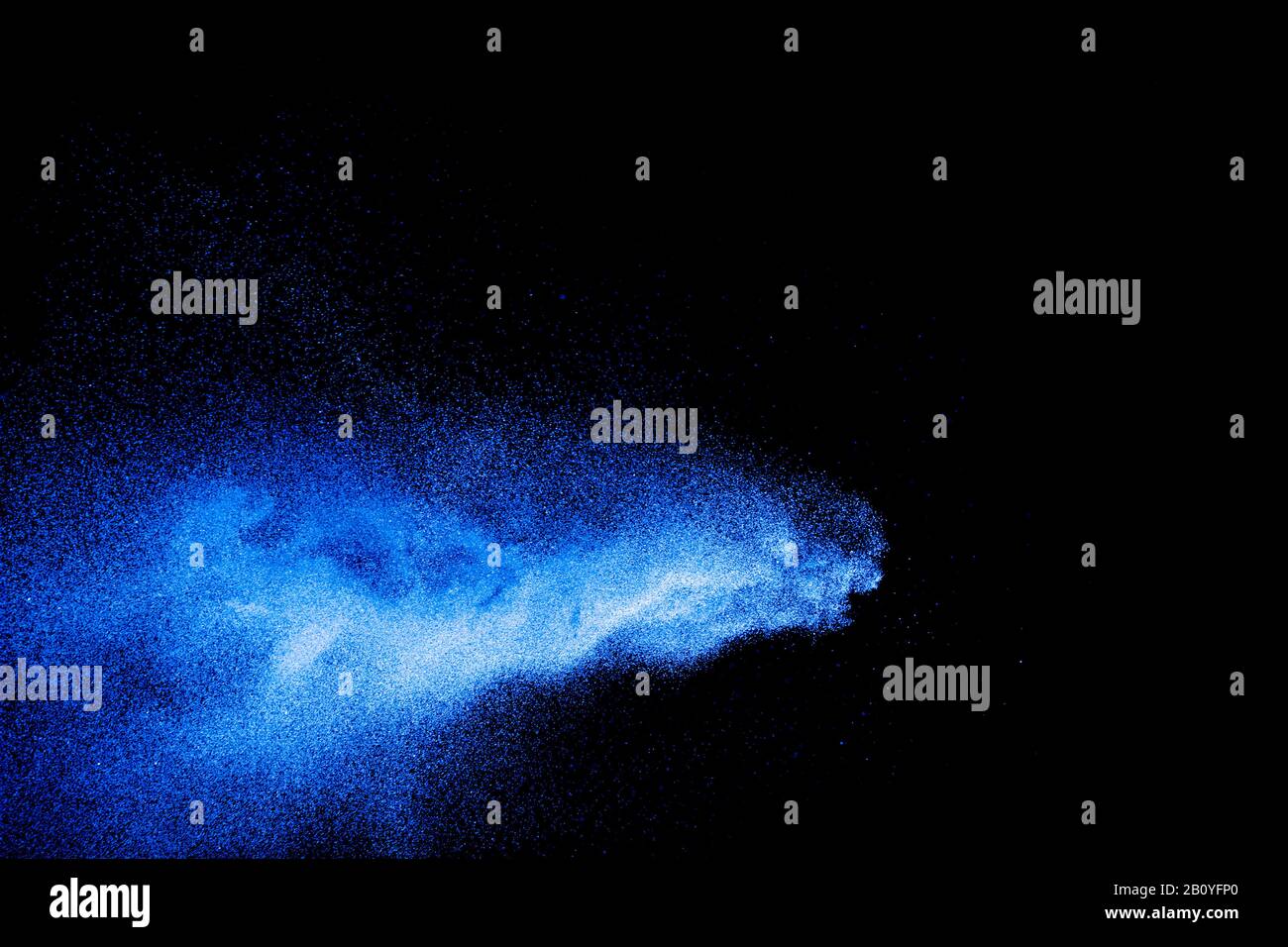 Blue color dust particles explosion cloud on black background.Color ...