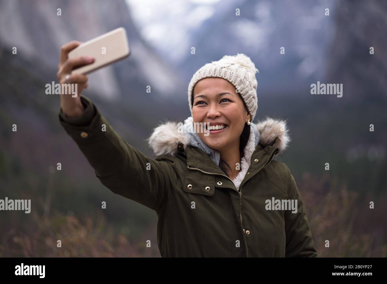 Smiling Young Woman Tourist Taking Selfie During Yosemite Winter Stock Photo