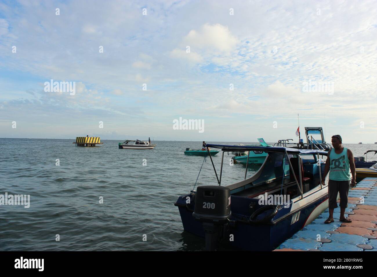 Man and the boat at Tanjung Batu Port Stock Photo