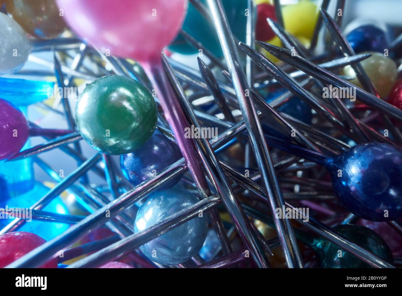 Background from sewing pins with multi-colored round heads on a light background Stock Photo