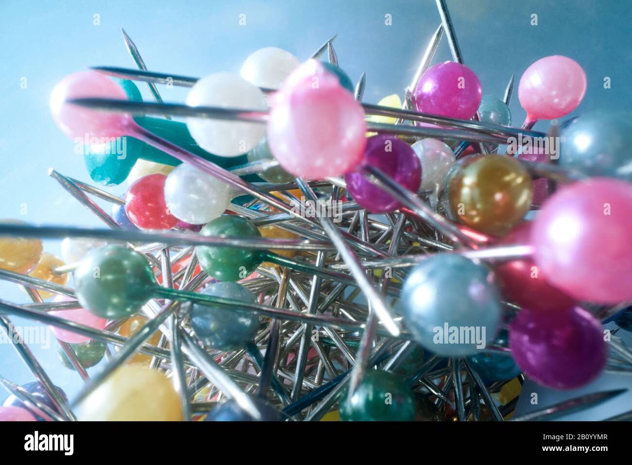 Background from sewing pins with multi-colored round heads on a light background Stock Photo