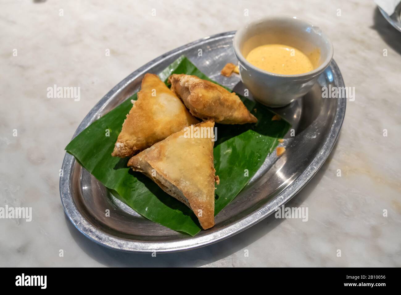 Samosas and dipping sauce on tray Stock Photo Alamy