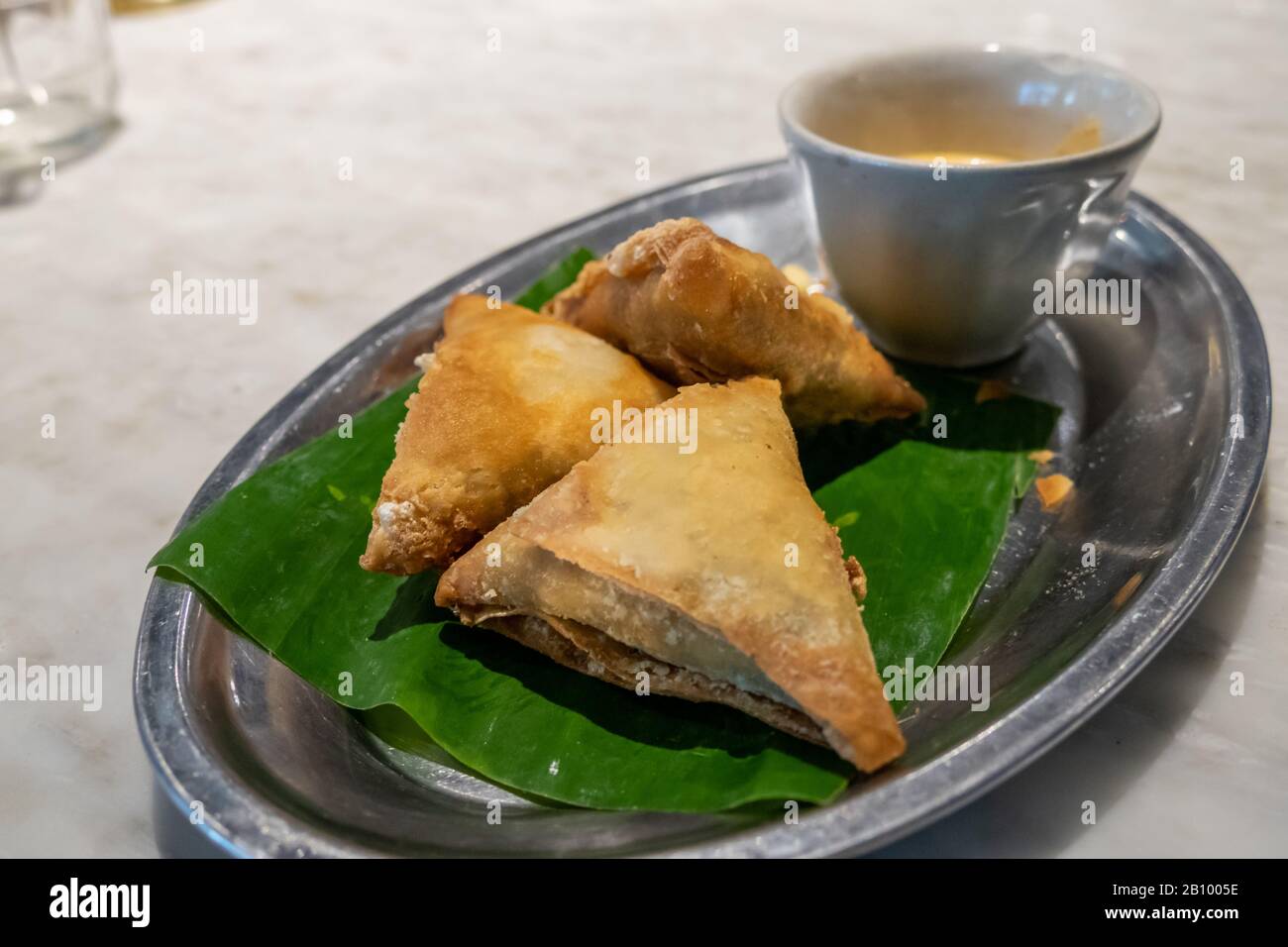 Samosas and dipping sauce on tray Stock Photo Alamy