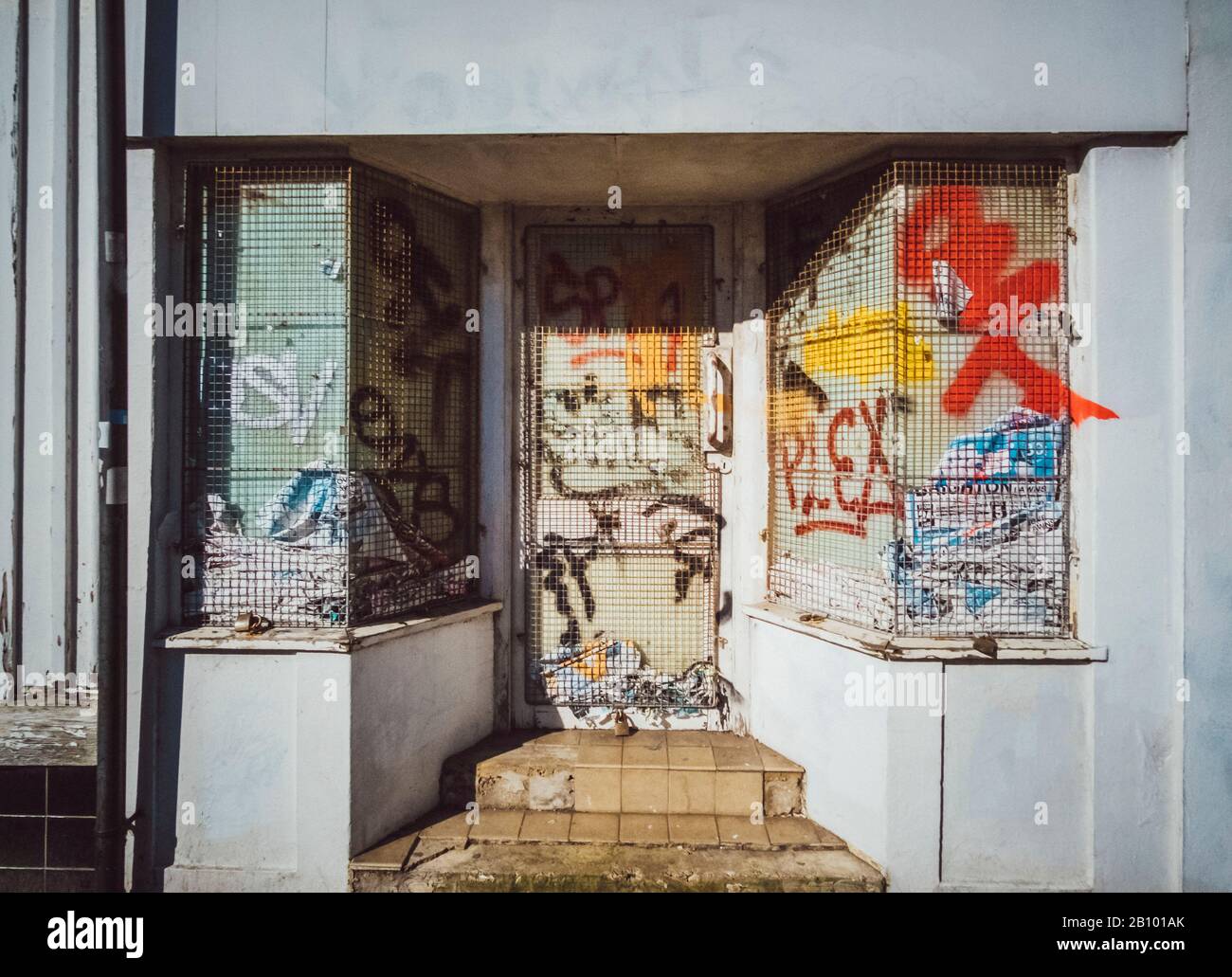 Graffitti on a barred front door, Brighton, England Stock Photo