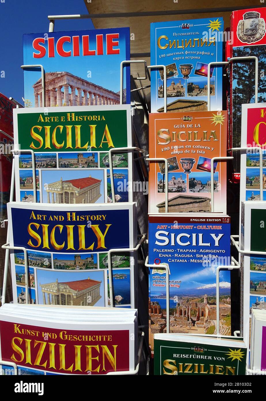 Guide books and illustrated books on a rack at a shop, old town of Taormina, Sicily, Italy Stock Photo