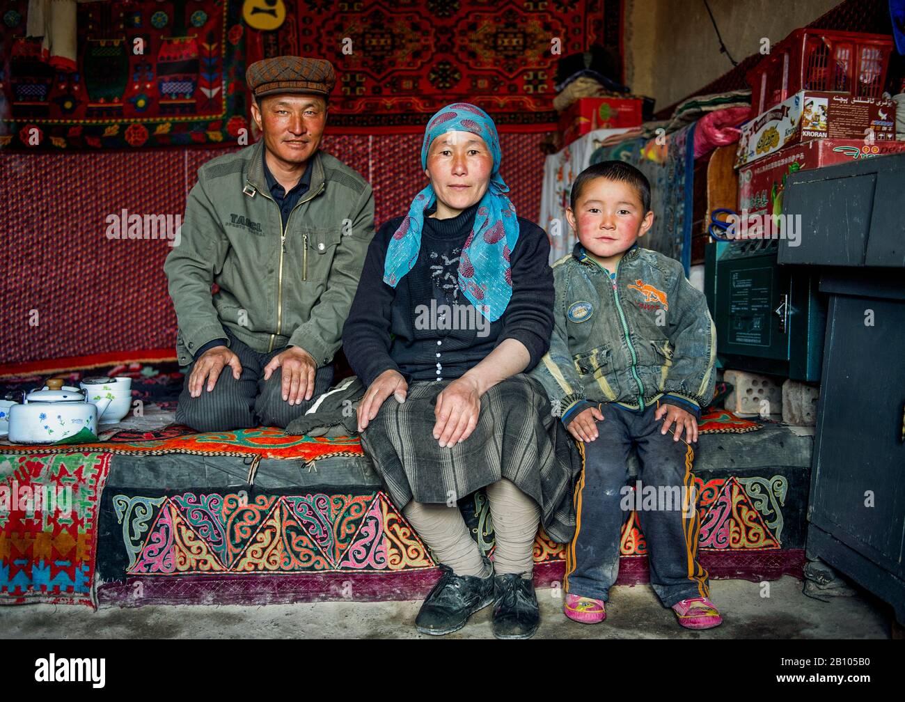 Uighur houses are very basic and have only one room that servers as kitchen and room. Families spend their spare time sitting around, sipping tea together. Stock Photo