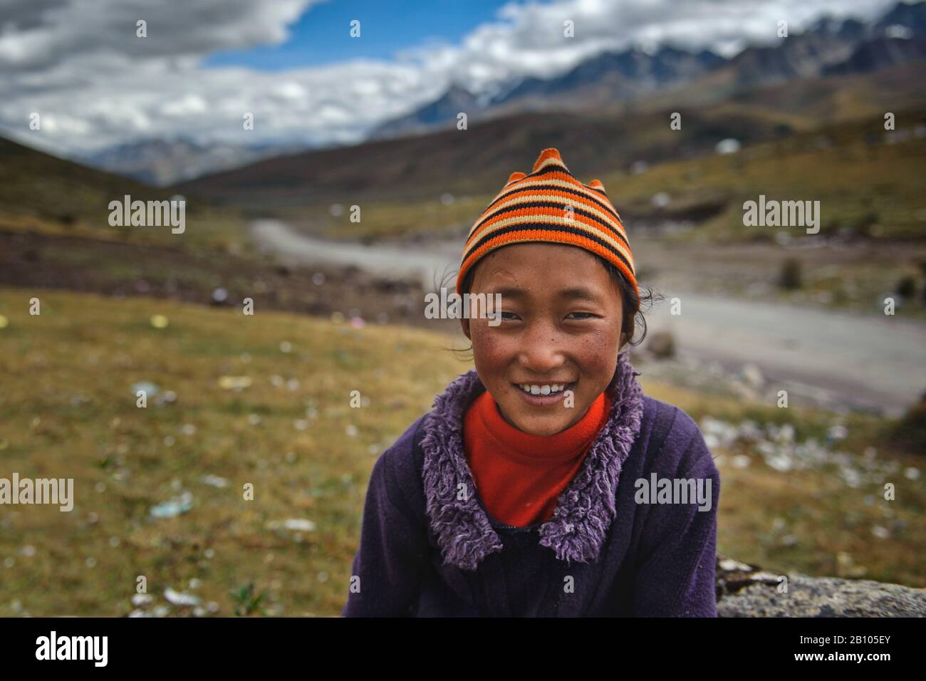 Tibetan kids from nomad families wander around their camp sites during day and greet their visitors. Tibetan plateau Stock Photo