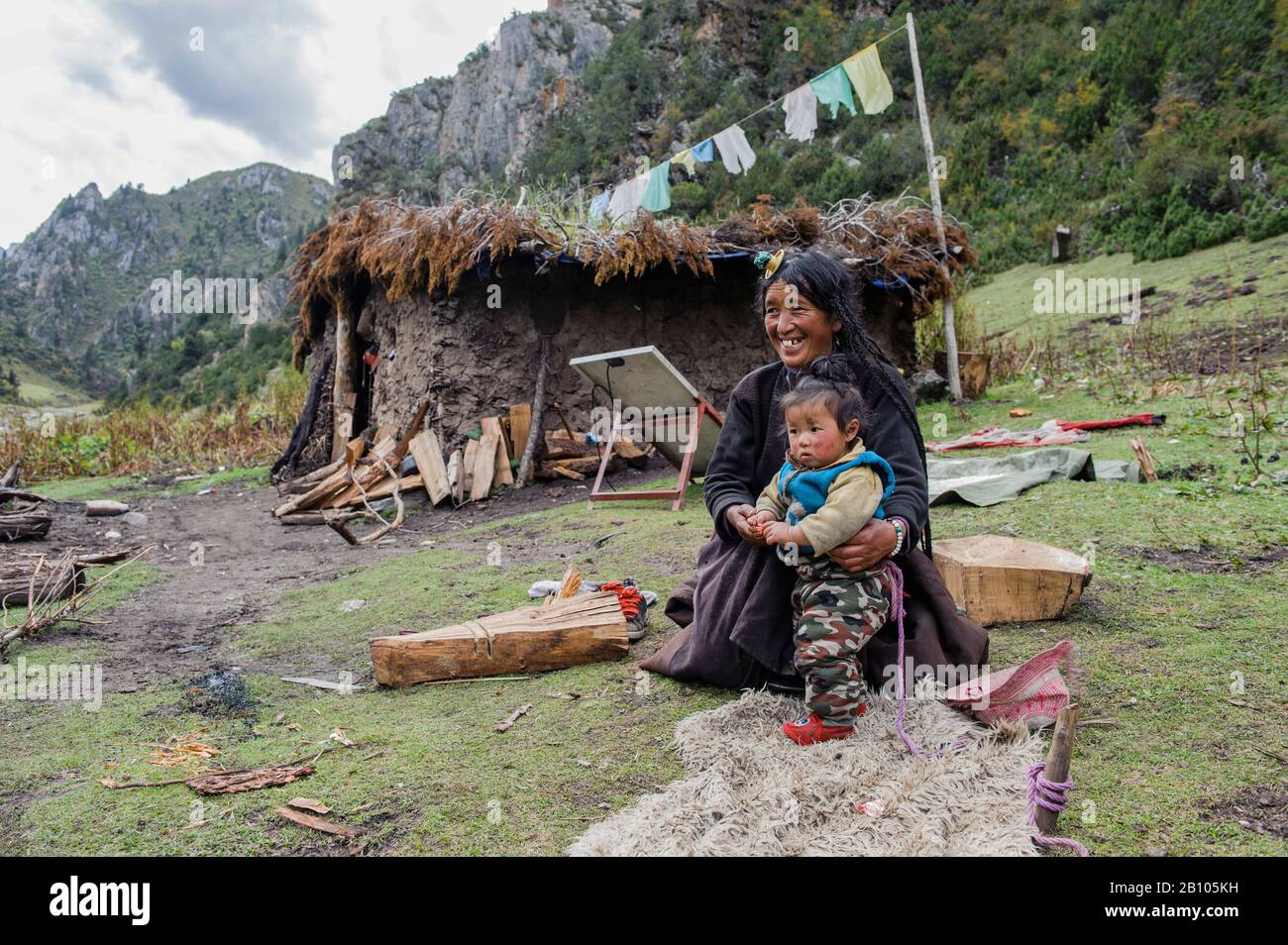 Tibetan families stick together. While parents work, grandparents are in charge of looking after their grandchildren. Remote Tibetan plateau Stock Photo