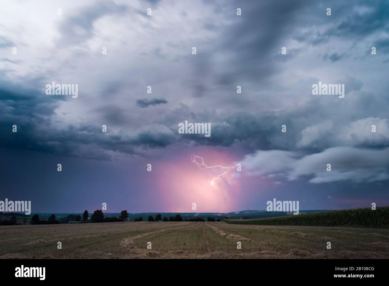 Precipitation illuminated by lightning on the back of a withdrawing supercell near Feuchtwangen, Baden-Württemberg, Germany Stock Photo