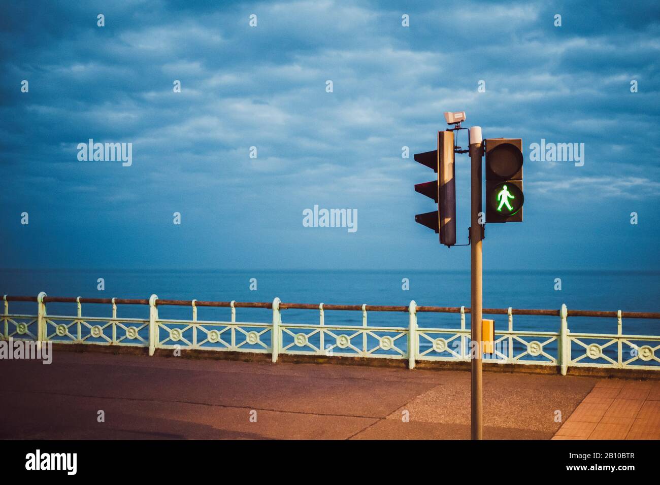 Green pedestrian lights in the evening, Brighton Beach, Brighton, England Stock Photo