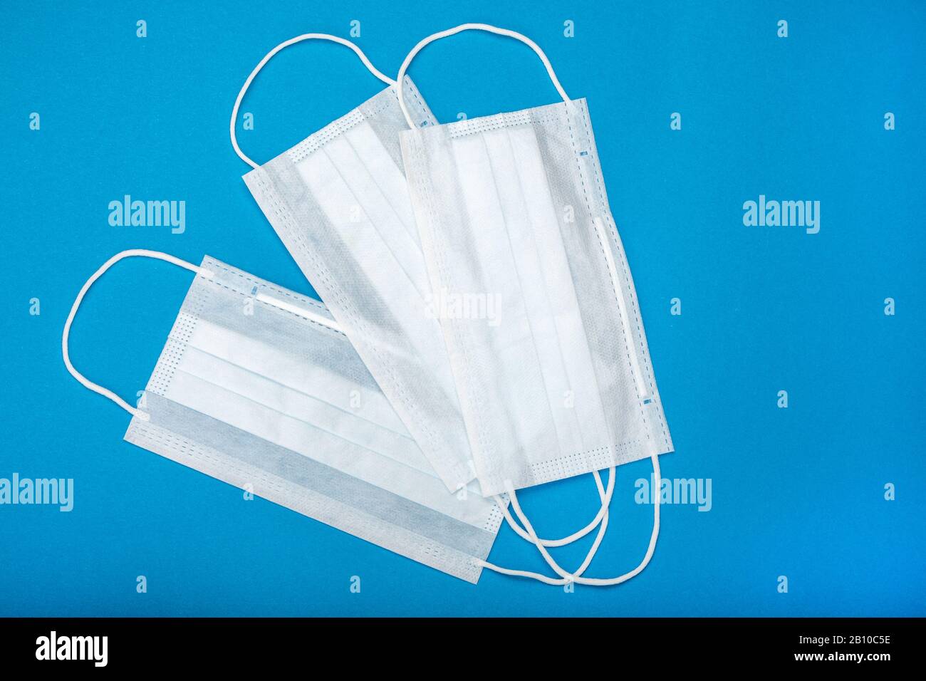Two surgical masks with rubber ear straps. Typical 3ply surgical mask to cover the mouth and