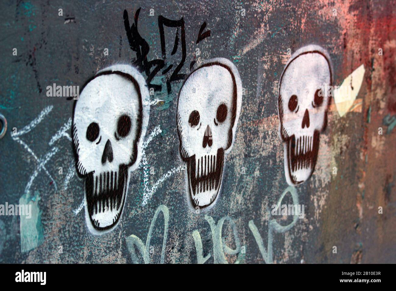 Street art. Mural. Stencil graffiti skulls on a wall in Kallio district of Helsinki, Finland. Stock Photo