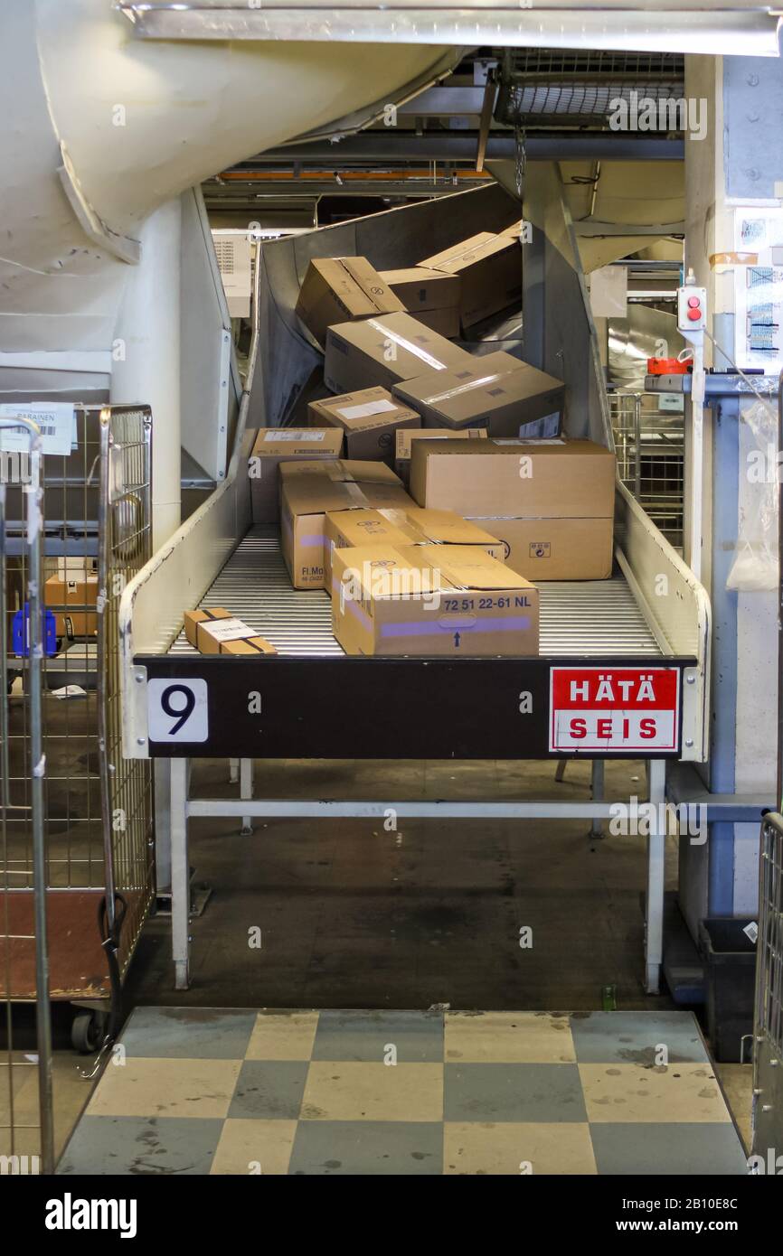 Postal parcels in a parcel sorting machine chute waiting to be sorted by destinations Stock Photo