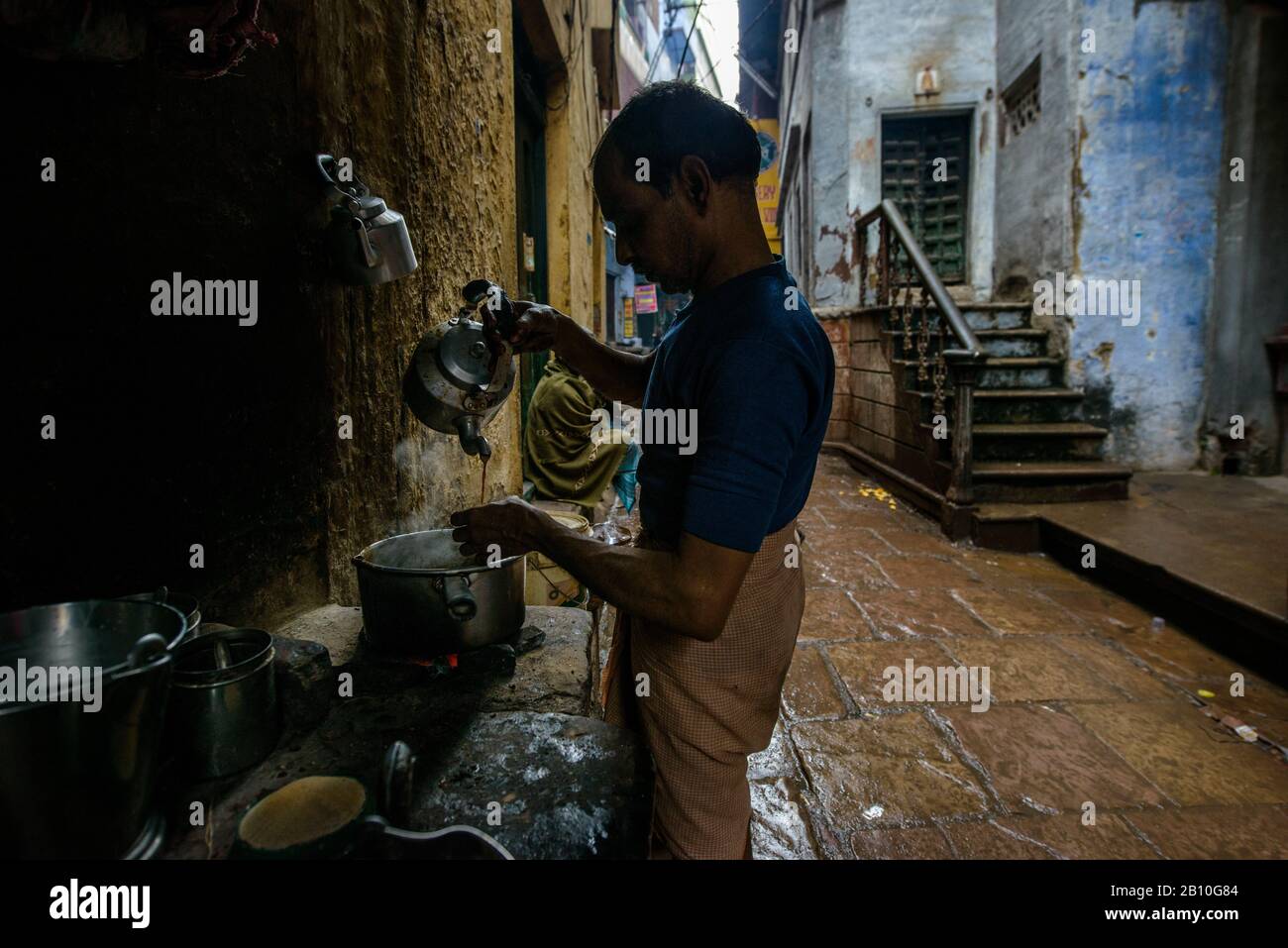 Chai manufacturer in the streets of the old city of Varanasi, India Stock Photo