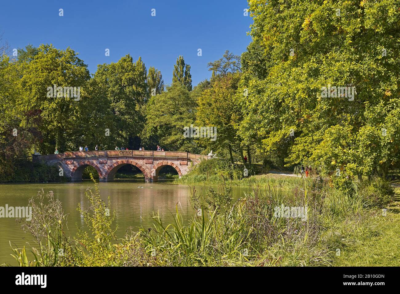 Red bridge in Schönbusch Park, Aschaffenburg, Lower Franconia, Bavaria, Germany Stock Photo