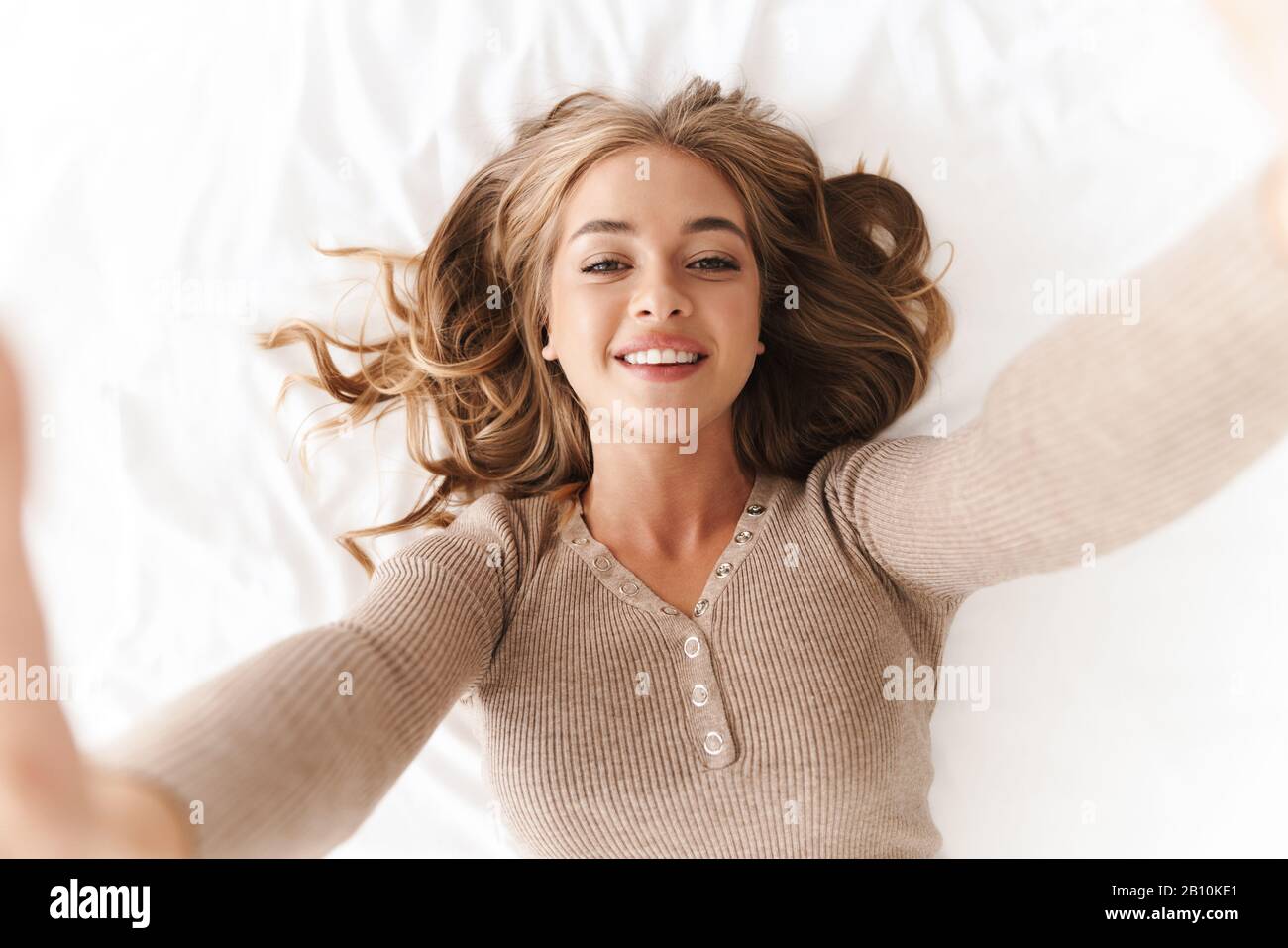 Photo of young cheerful woman with blonde hair taking selfie photo and ...