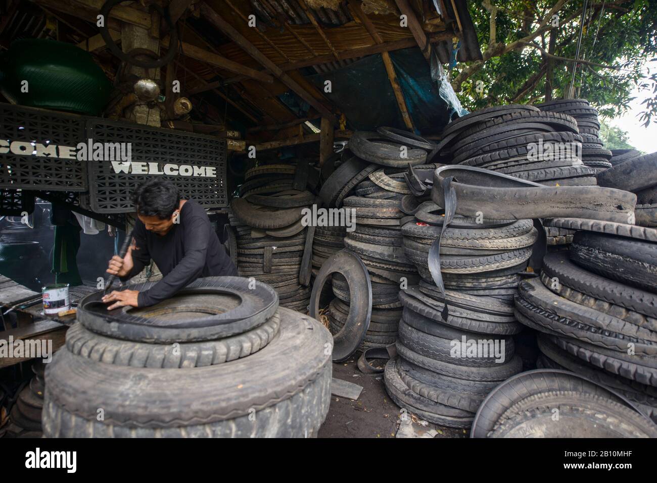 Recycling, man builds furniture from old truck tires, South Luzon, Philippines Stock Photo