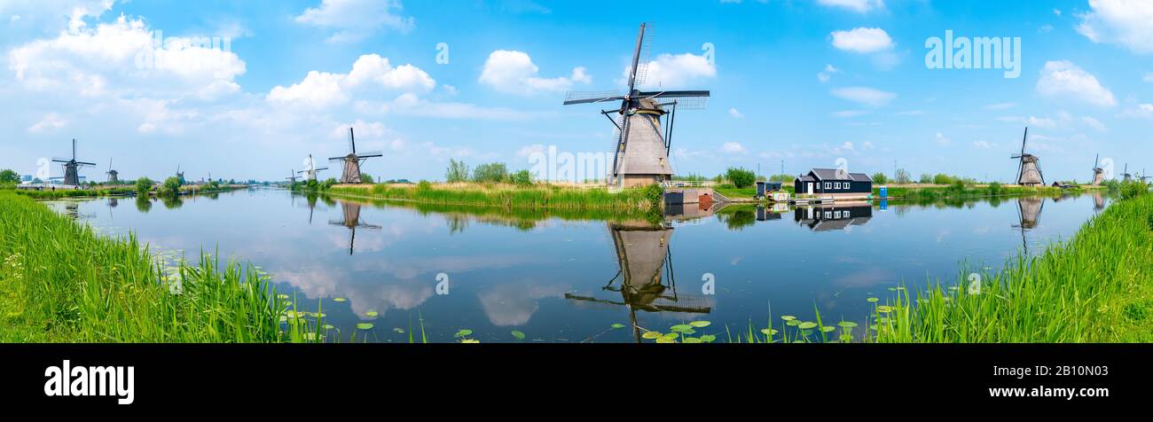 Panorama of the windmills and the reflection on water in Kinderdijk, a UNESCO World Heritage site in Rotterdam, Netherlands Stock Photo
