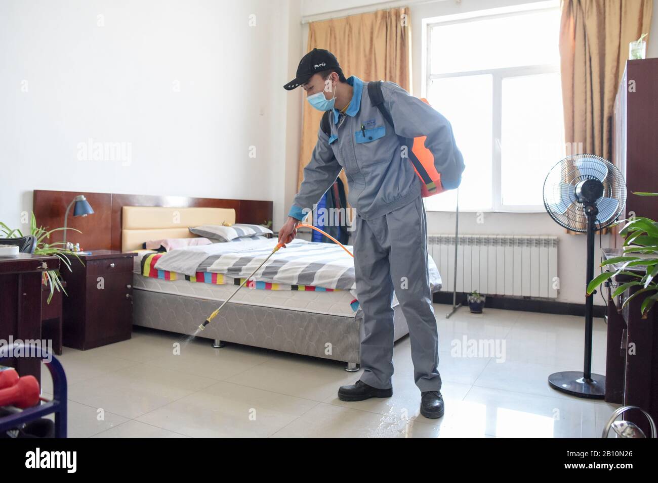 Urumqi, China's Xinjiang Uygur Autonomous Region. 22nd Feb, 2020. A staff member of the Wuhu Conch Profiles and Science Co., Ltd. disinfects a dormitory in Urumqi, northwest China's Xinjiang Uygur Autonomous Region, Feb. 22, 2020. Some companies in Urumqi have resumed production amid strict prevention and control measures against the novel coronavirus. Credit: Ding Lei/Xinhua/Alamy Live News Stock Photo