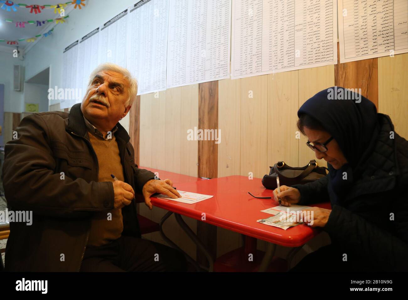 February 21, 2020: Iranians vote during parliamentary election at a polling station in downtown Tehran, Iran. Conservatives are expected to dominate the general election after an economic slump, multiple crises and the disqualification of thousands of candidates. Voters formed long lines at polling stations in south Tehran, where conservatives have a solid support base, but far fewer were seen waiting to vote in upmarket northern neighborhoods. Credit: Rouzbeh Fouladi/ZUMA Wire/Alamy Live News Stock Photo