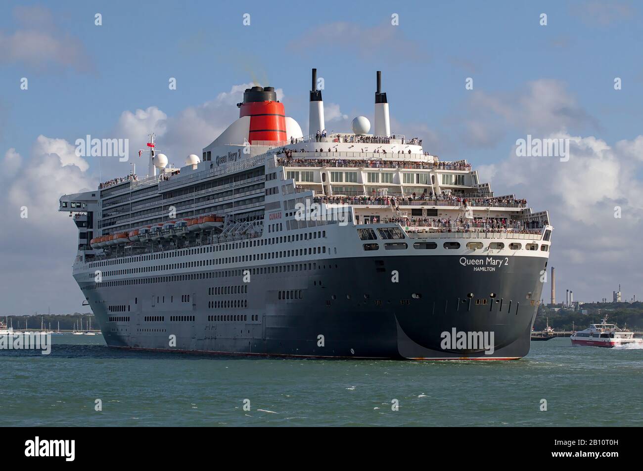 Stern Of The Queen Mary Two Departing Southampton Docks As Part Of The Three Queens Showing Passengers Waving Stock Photo