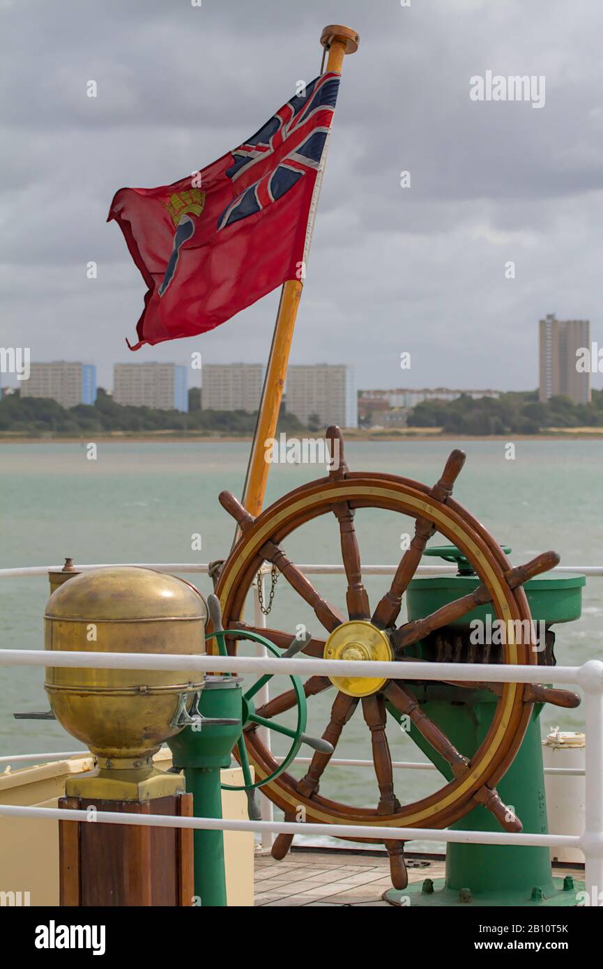 Royal Ensign Flag And Ships Wheel On The Stern Of The SS Shieldhall