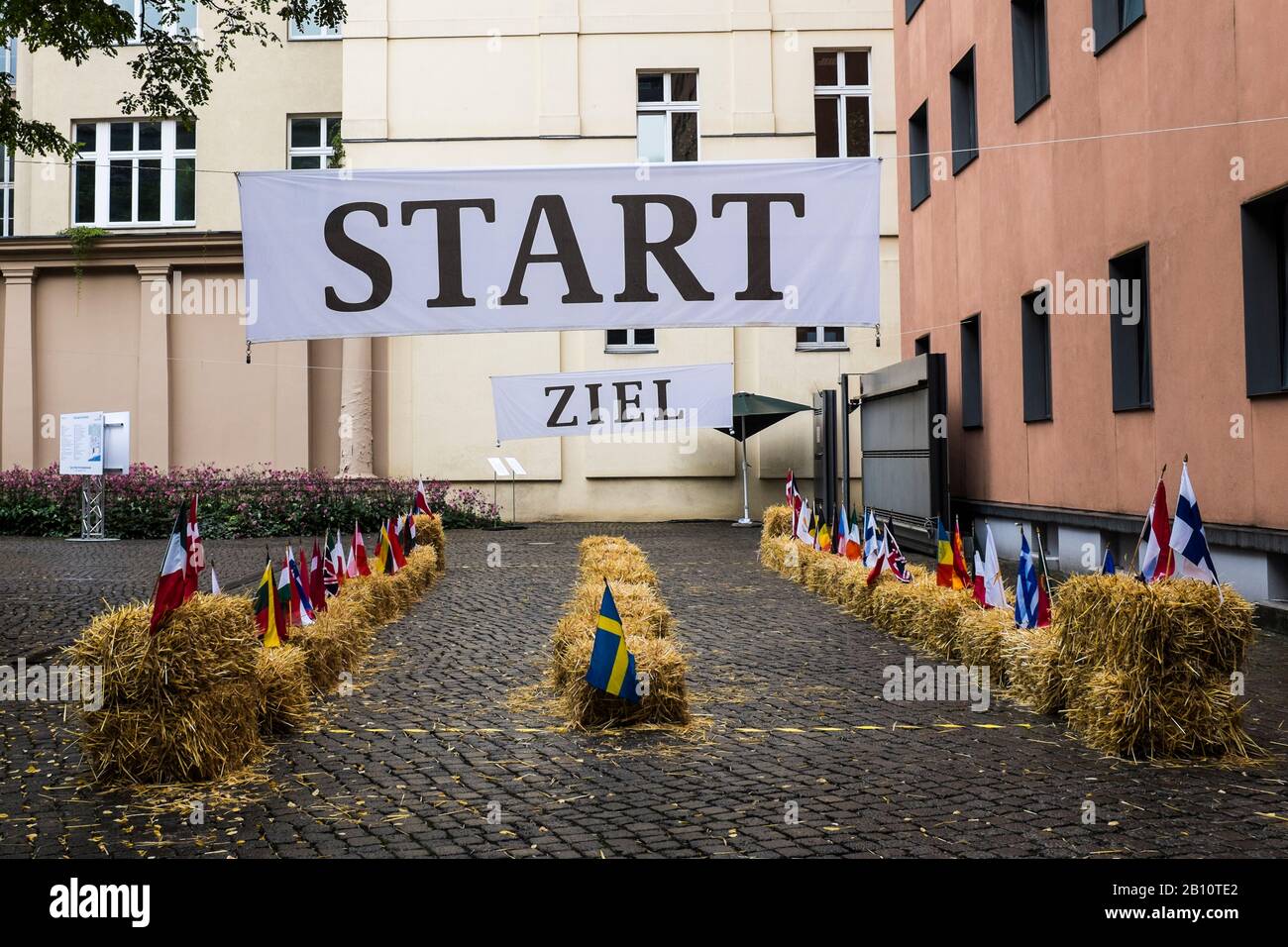 Start and finish on a race track with national flags Stock Photo - Alamy