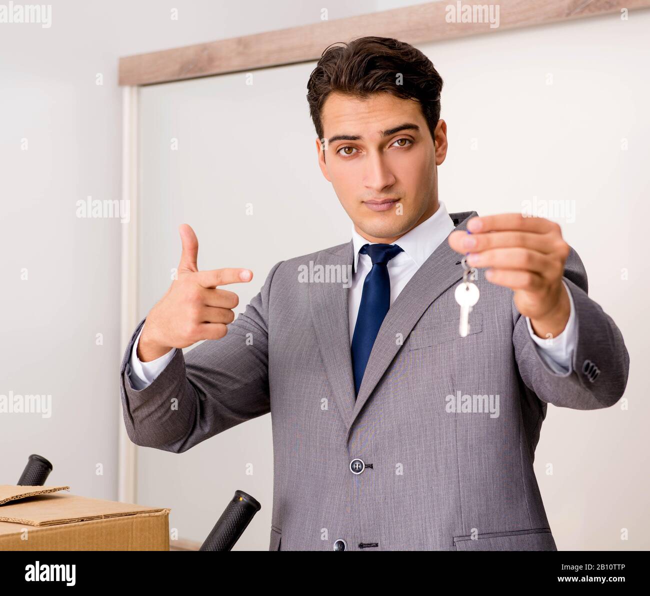 The real estate agent with key from new house Stock Photo Alamy