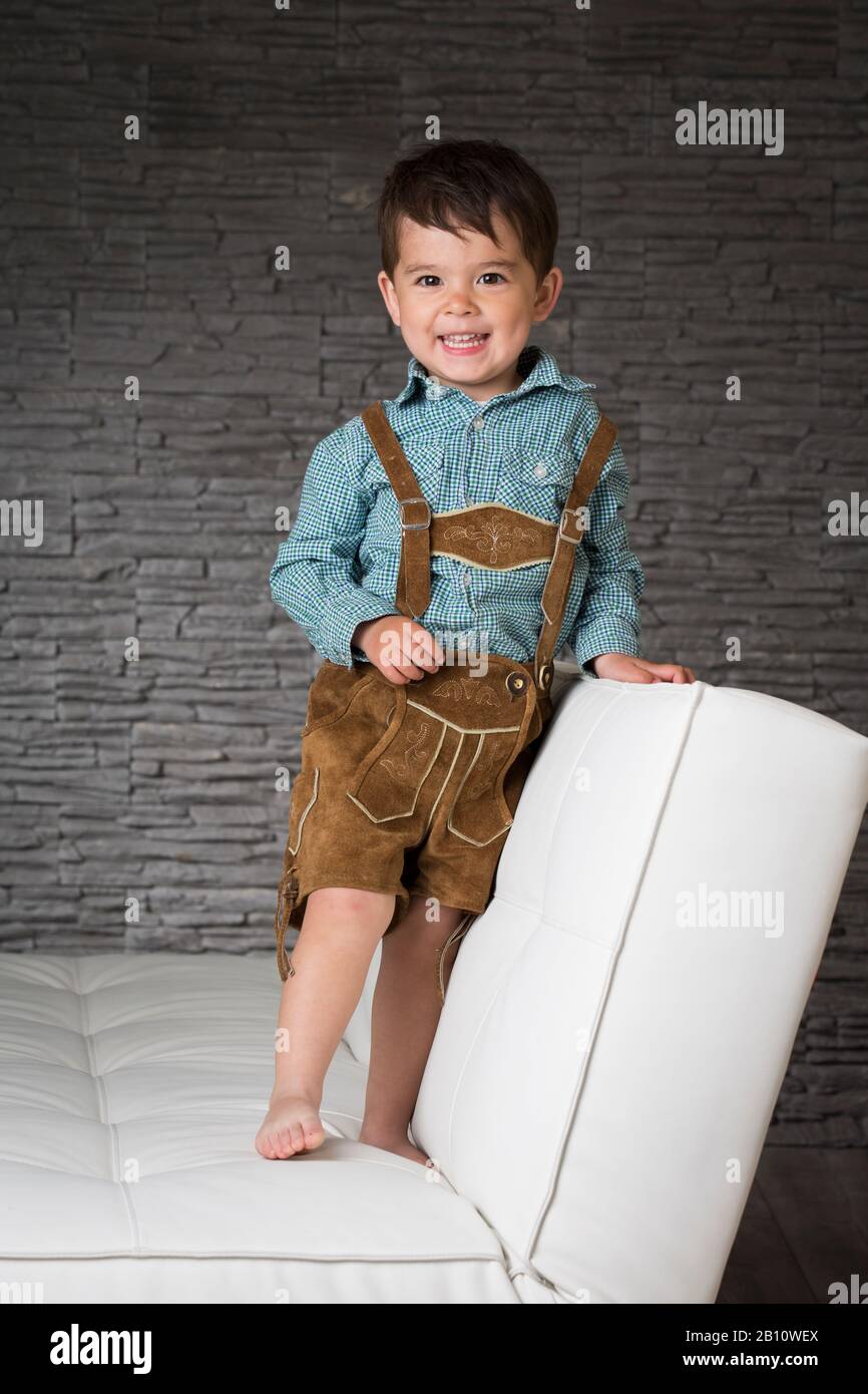 Little boy with leather pants on the sofa Stock Photo Alamy