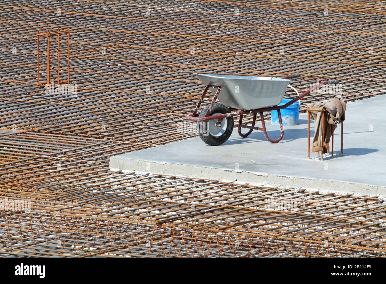 wheelbarrow on concrete at construction site Stock Photo