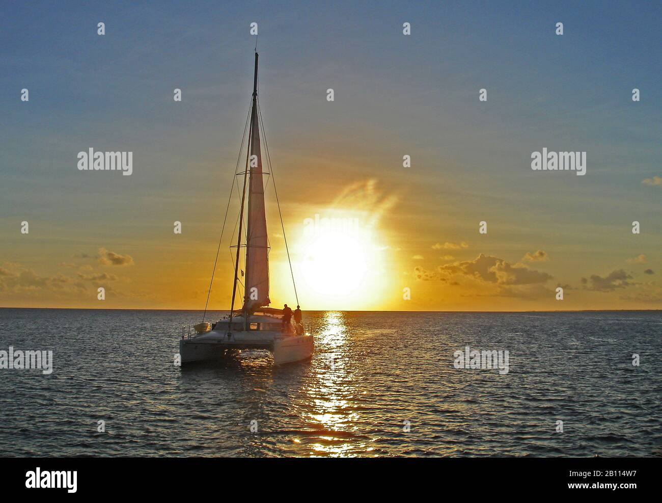 Catamaran at sunset, Polynesia Stock Photo