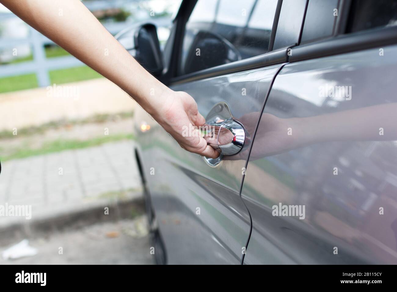 Close up of a man opens car's door. Stock Photo