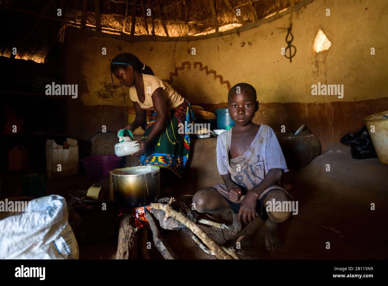 Everyday scene in a traditional straw hut, Mozambique, Africa Stock Photo