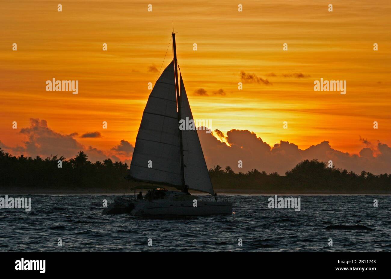 Catamaran in sunset, Polynesia Stock Photo