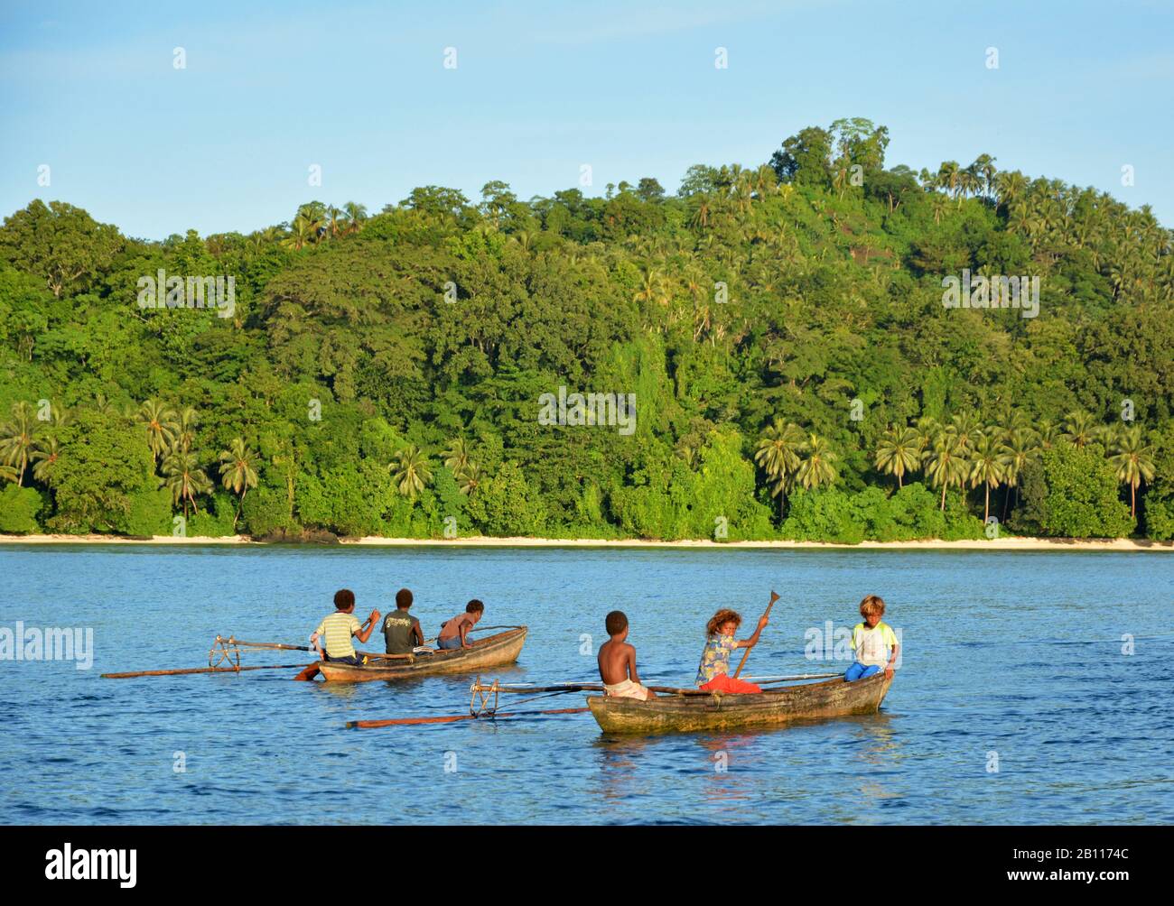 Coast of Makira Island and boats with natives, Solomon Islands, Makira Island Stock Photo