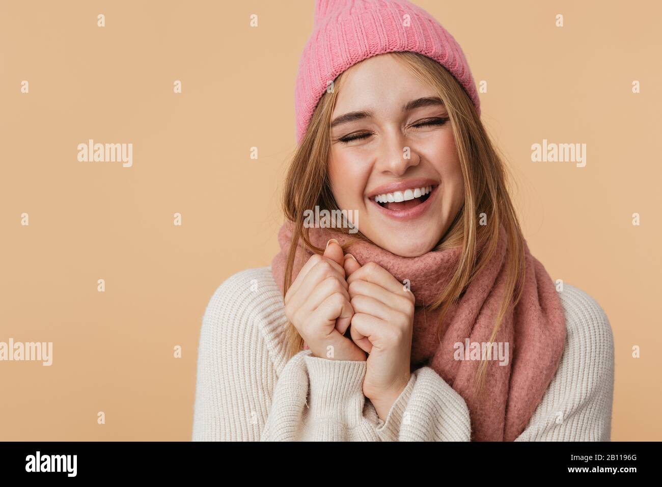 Image of young attractive girl wearing winter hat and scarf smiling and ...