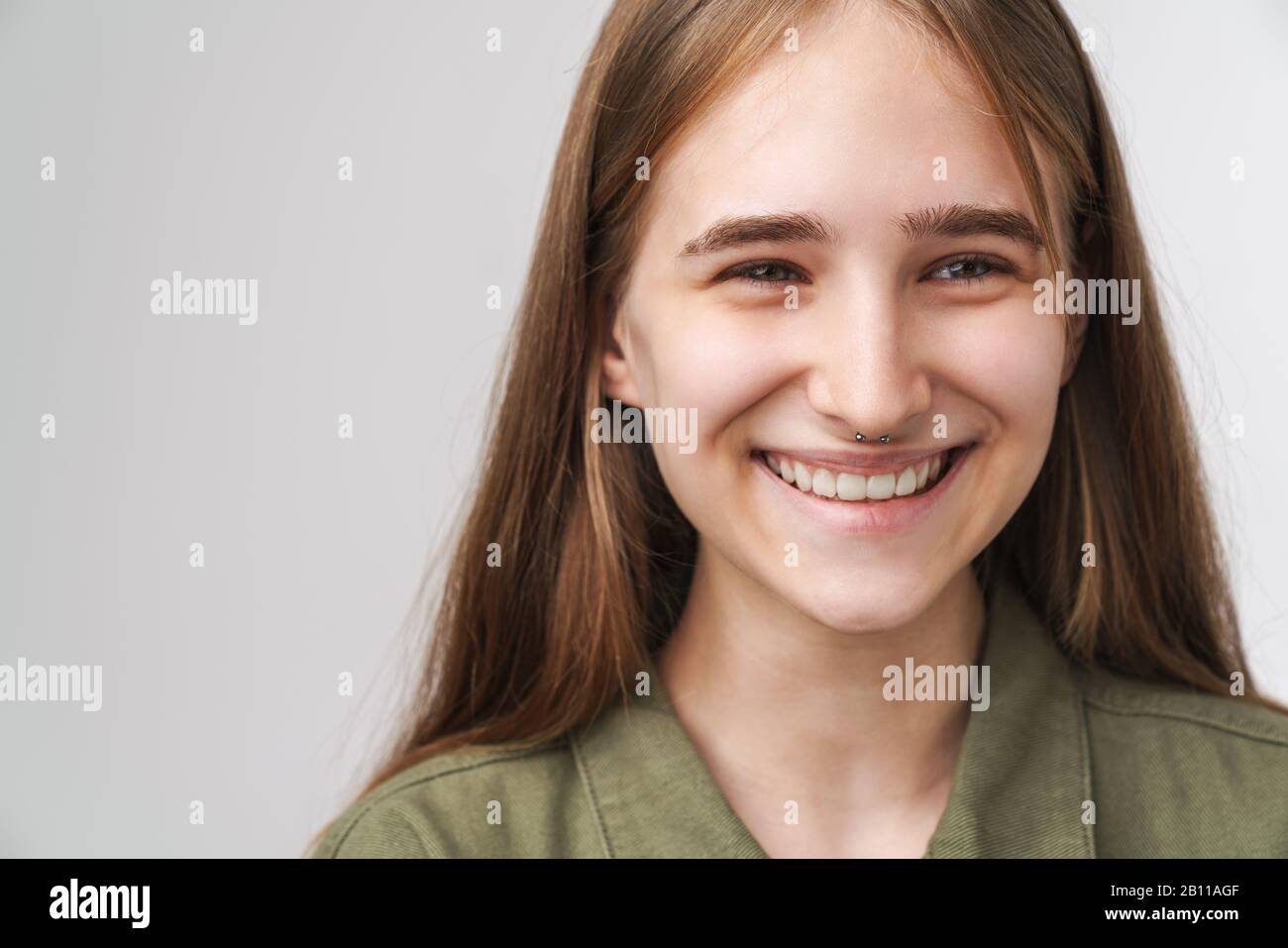 Close up portrait of a smiling pretty young girl with long blonde hair ...