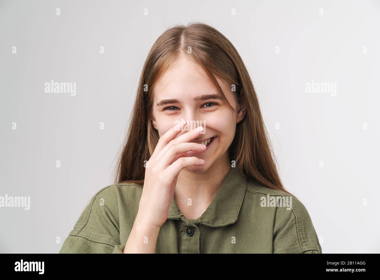 Close up portrait of a smiling pretty young girl with long blonde hair ...