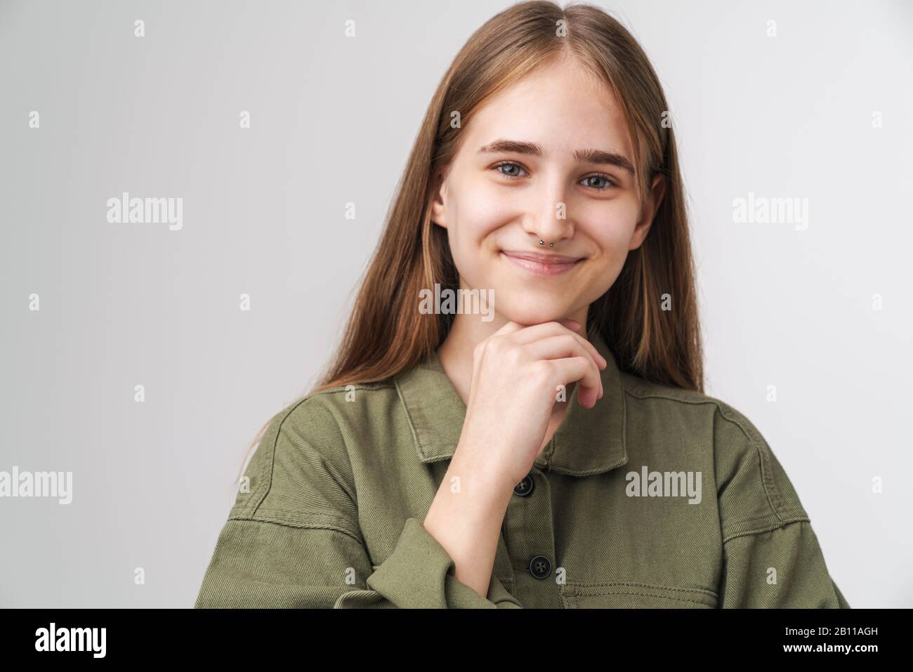 Close up portrait of a smiling pretty young girl with long blonde hair ...