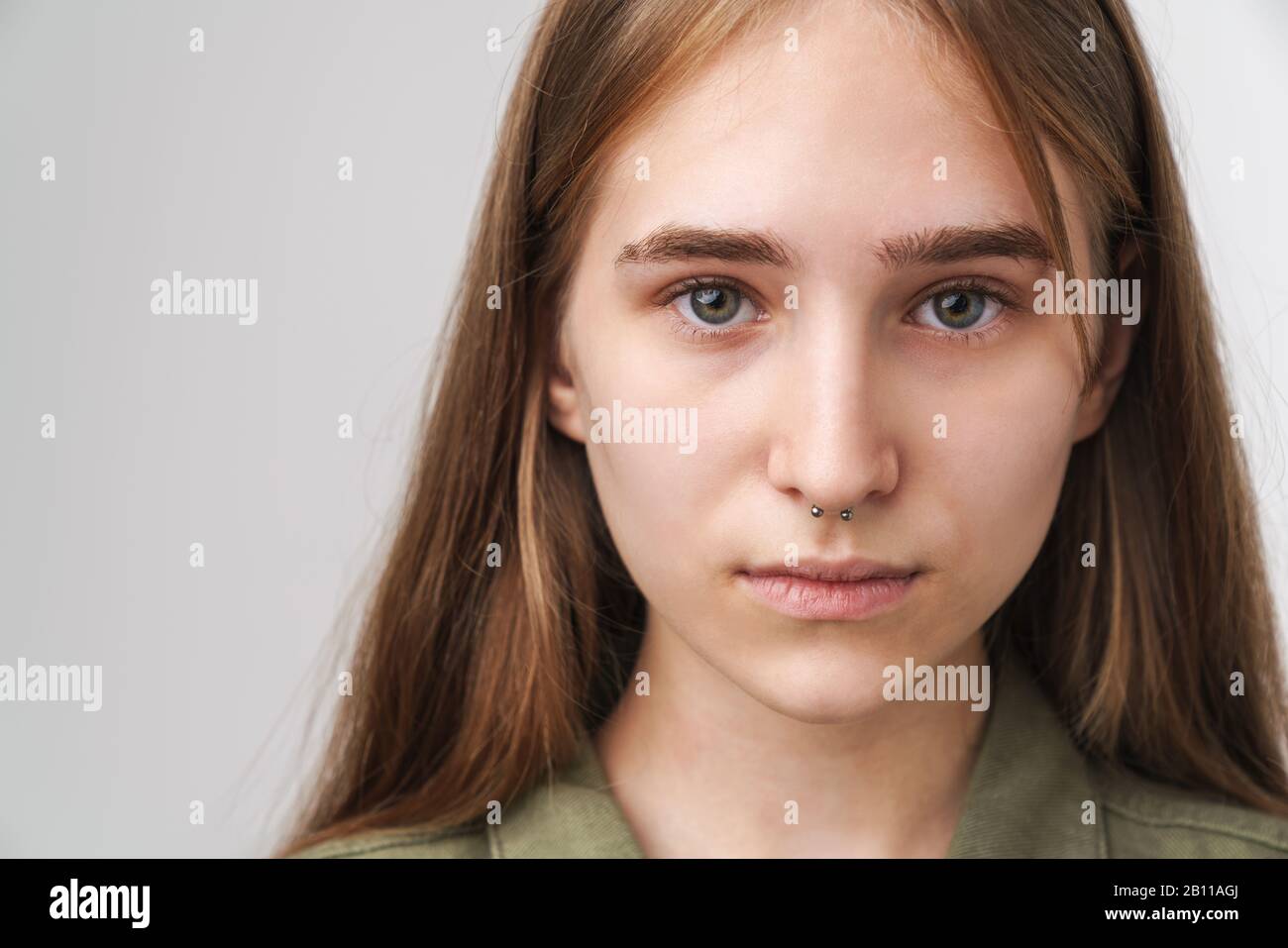 Close up portrait of a pretty young girl with long blonde hair standing ...