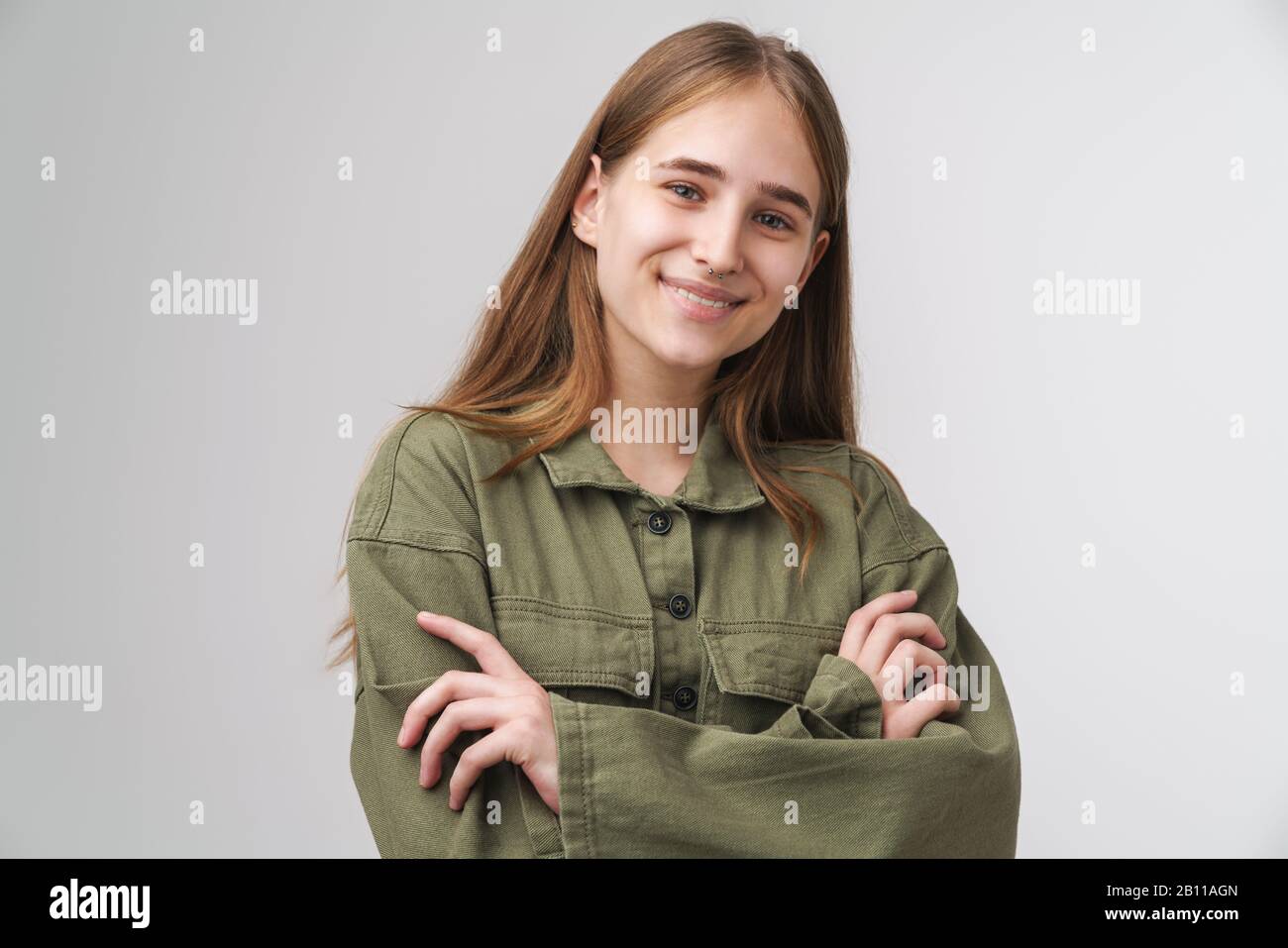 Close up portrait of a smiling pretty young girl with long blonde hair ...