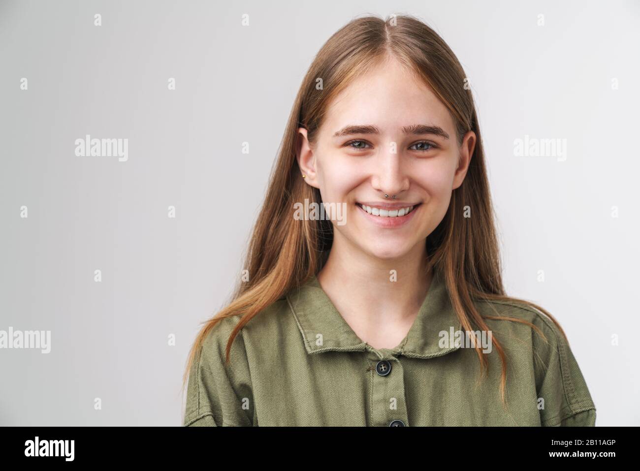 Close up portrait of a smiling pretty young girl with long blonde hair ...