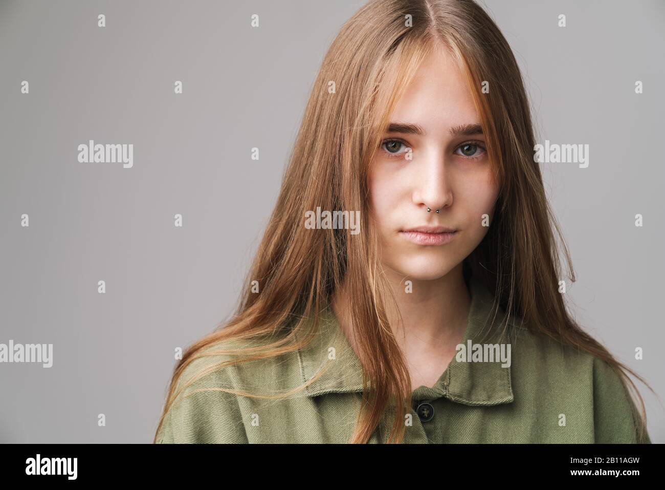 Close up portrait of a pretty young girl with long blonde hair standing ...