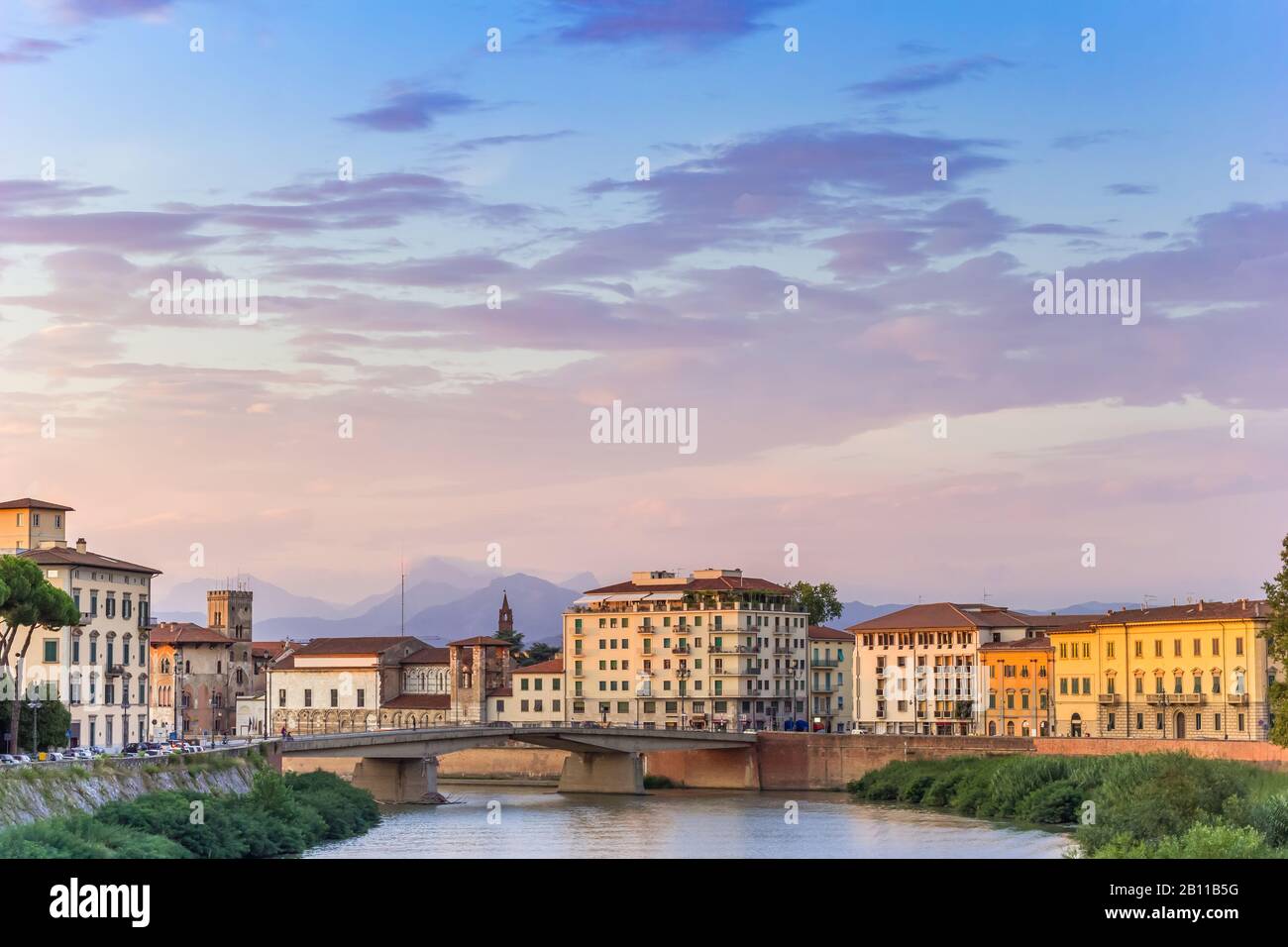 River Arno and colorful buildings in the evening light in Pisa, Tuscany, Italy Stock Photo