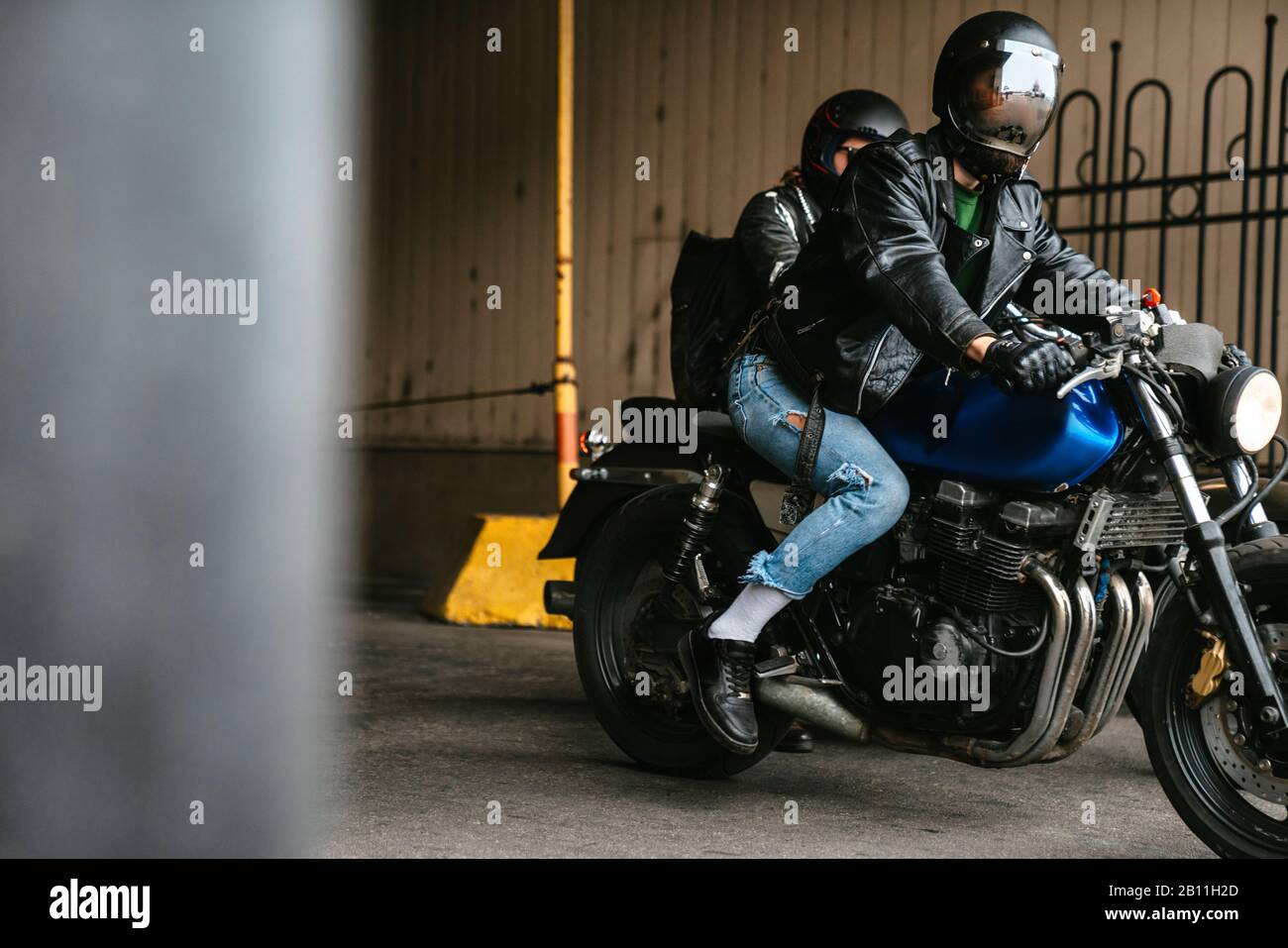 Photo of young caucasian men bikers wearing helmets sitting on their