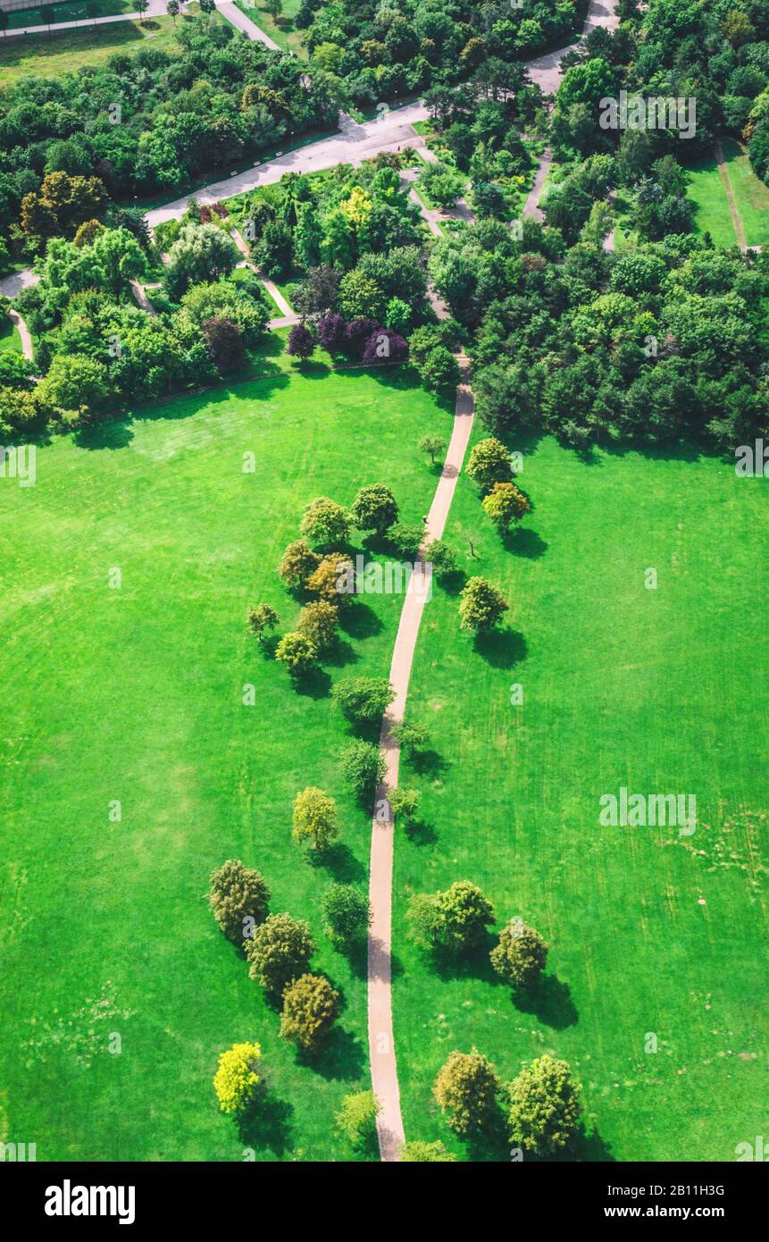 Aerial view of green park with winding road. Vertical photo Stock Photo ...