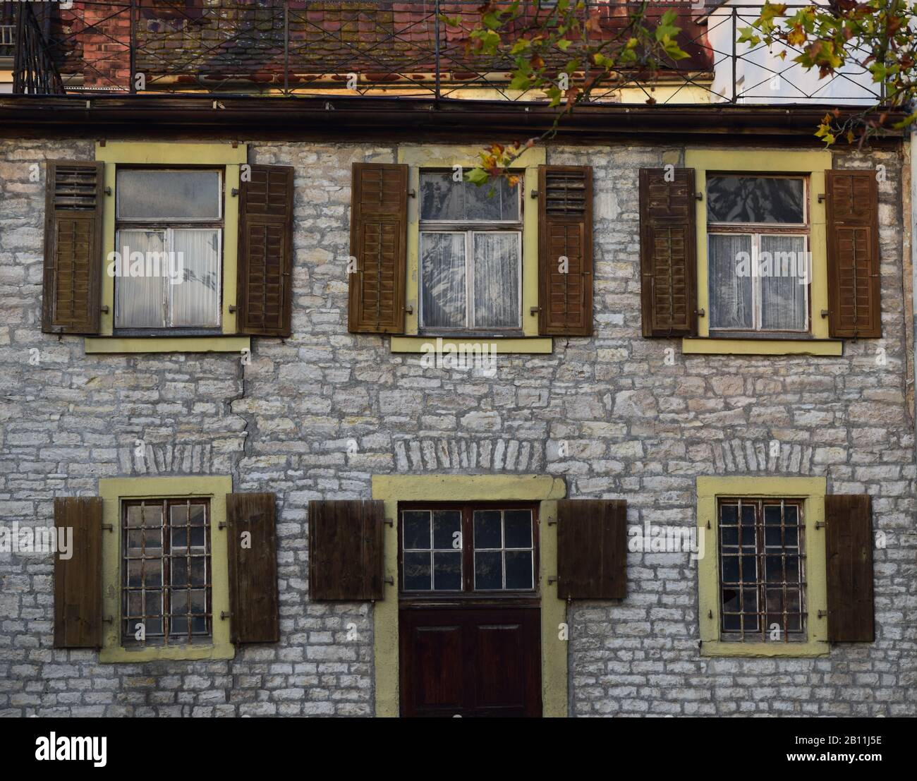 old Stone house with wooden Shutters Stock Photo - Alamy